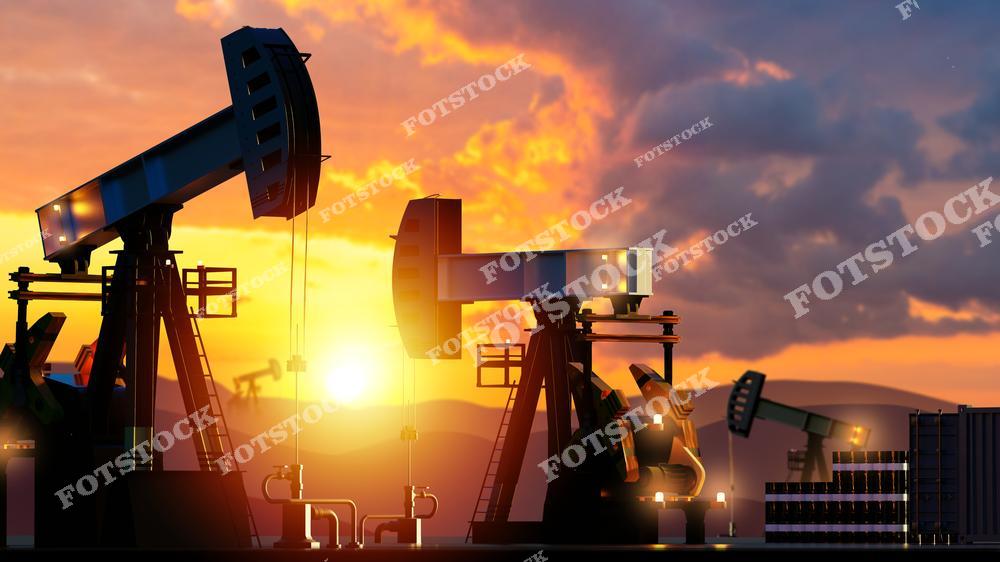 На изображении силуэты нефтяных качалок на фоне заката. Атмосферный пейзаж подчеркивает важность нефтедобычи и ее роль в энергетическом секторе.